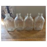 4 - 1/2 gallon milk bottles