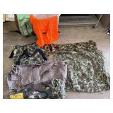 Camo bag containing tarp, orange vest, netting and