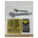 Adjustable wrenches and bit sets