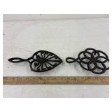 2 cast iron footed trivetts