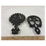 2 vintage cast iron trivetts, eagle & good luck