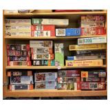 LOT OF JIGSAW PUZZLES- UPPER CABINET