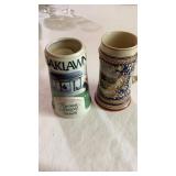 Two beer steins one is Oakland silver