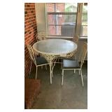 Metal table with glass top measures 41.5 inches