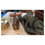 Two carry on bags, five purses and a brass