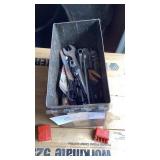 Metal bin containing misc wrenches, scissors,