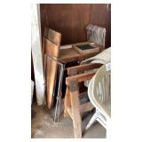 2 wooden sawhorses, 2 plastic chairs, rug,