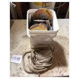 Bucket of Grinding Discs and Rope