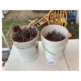 Two Buckets of 7-Inch Nails