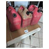 Three Red Plastic Gas Cans