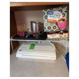 Food saver, vacuum, sealer, kitchen shelf, knife, sharpeners, powdered sugar, sifter, tea, and coffee ￼