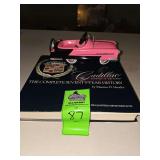 Pink die-cast "Kidillac" hallmark keepsake car and Cadillac history hard cover book
