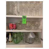 Cupboard full of glassware, salt and pepper shakers little pitchers, tumblers, champagne, flutes, wine, decanter wine glasses
