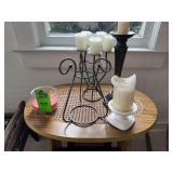 Wooden magazine rack, and items on top, including candles with candle holders