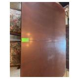 Dining room table with five chairs and a couple of leaves