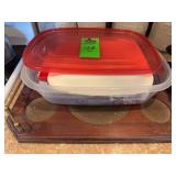 Plastic storage tub with plastic spoons and straws.  Wood serving tray
