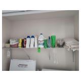 Cleaning supplies and towels everything on the shelf