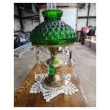 vintage green glass oil lamp with a diamond-quilted shade and hanging prisms.