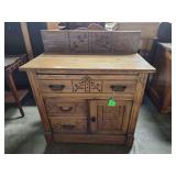 antique Eastlake-style commode or washstand with spoon carvings, likely from the Victorian era.