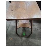 antique oak parlor table with barley twist legs and a lower shelf.