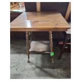 antique oak parlor table with barley twist legs and a lower shelf.