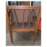vintage mid-century wooden record cabinet with multiple slots for storing vinyl records.