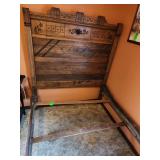 rustic wooden headboard with carved floral and geometric patterns and bed frame , double size