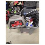 Tote with battery charger laser lights and lawn fertilizer