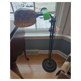 Art Nouveau style floor lamp with a mottled amber glass shade and a vintage bronze finish.