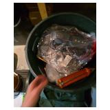 Trash can filled with wires and tools