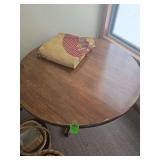 Round pedestal table with woven table cloth