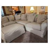 Corner sofa with ottoman and pillows