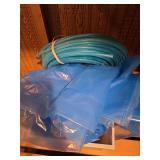 Blue tubing and tarp sandpaper and sander