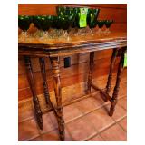 Vintage wood side table featuring turned legs and a polished tabletop. (Glassware not included)