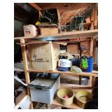 Contents of shelf. Dog bowls, barbed wire, hats carpet