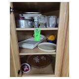 Contents of cupboard, baking dishes, lazy Susan, food trays
