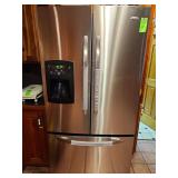 Amana refrigerator with a water and ice dispenser in front door