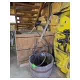 Wood barrel and antique farm tool