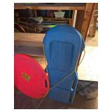 Multiple snow sleds and 2 snow boards