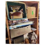 Contents of shelf. Bird feeder, tether ball, old cellphones, glasses, bed frames