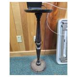 antique Victorian-style wooden pedestal plant stand or accent table.