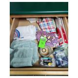 Contents of drawer, kitchen towels, batteries, plastic wrap, duct tape