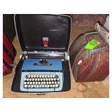 Bowling ball in bag and vintage typewriter in carrying case