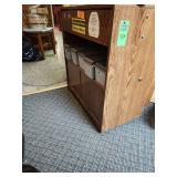 Wood stand on wheels with contents in the drawer and underneath