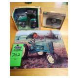 John Deer glass cutting board, belt buckle, and toy tractor, book, thermometer