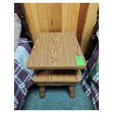 vintage two-tiered wooden side table featuring turned legs and a walnut veneer finish