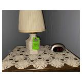 Contents of stand. Alarm clock, small lamp, doily