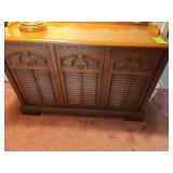 vintage RCA console, specifically identified as an RCA VTT310 LX, includes a turntable, radio, and speaker components.