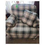 Set of plaid upholstered armchair features a classic wingback design and ottoman