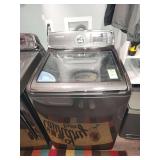 Samsung top-load washing machine, likely featuring ActiveWash™ technology which includes a built-in sink for pre-treating clothes